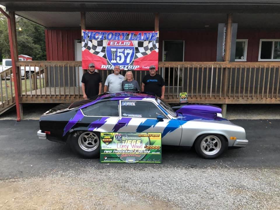 Pictured above, from the left, are Dustin Bryant, Phil and Sharon Bryant and Corey Wood, along with the Chevrolet Vega he piloted to a second place finish at the Summer Door Car Shootout, owned by Roger and Pam Burdell.